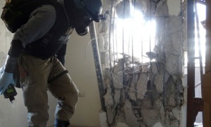 A UN chemical weapons inspector at one of the sites of the Aug. 21 chemical weapons attack in the Damascus suburb of Zamalka