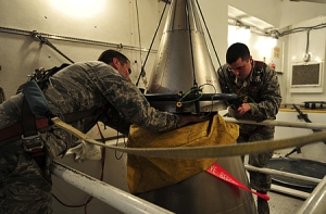 U.S. Air Force personnel perform New START Treaty inspection training on a Minuteman III ICBM payload section at Minot AFB in 2011. 
